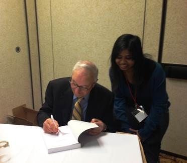 Dr. Bandura signing a book for a student at MPA, 2013.