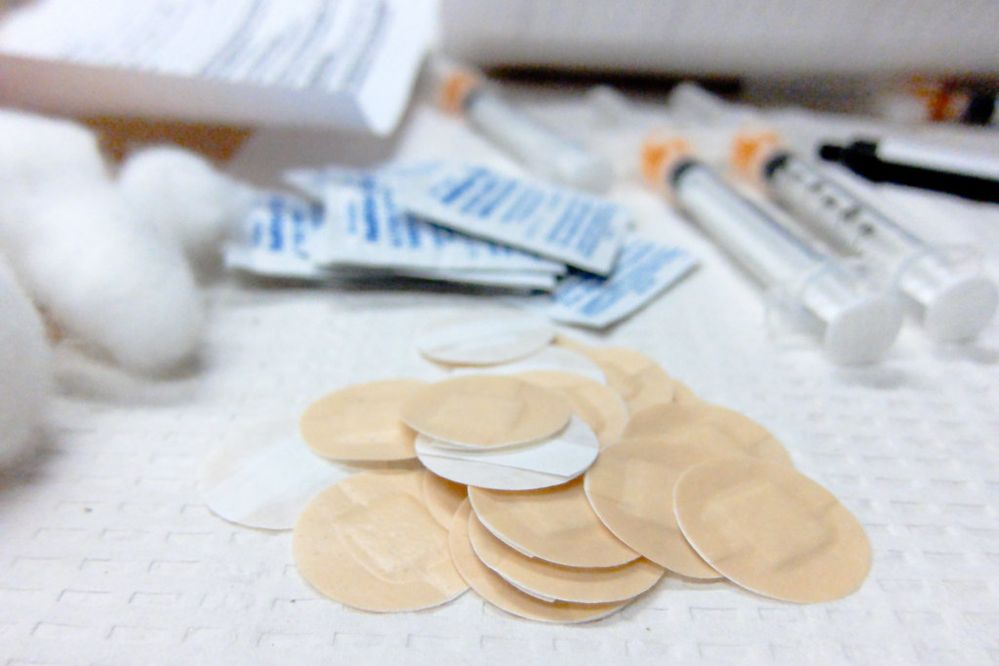 Close-up photograph of unused bandages, syringes, alcohol prep pads, and cotton balls.jpg