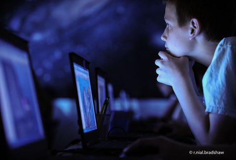 Boy using computer in classroom. "classroom-laptops-computers-boy" by R. Nial Bradshaw is licensed under CC BY 2.0.