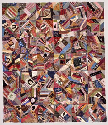 A quilt of many colors and shapes arranged in irregular patterns.jpg