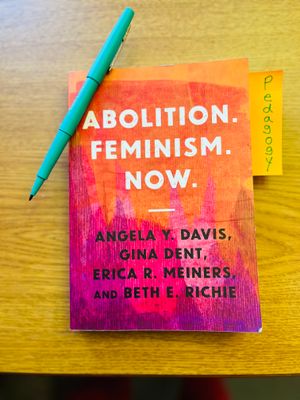 Book titled Abolition. Feminism. Now. pictured with blue pen and sticky note labeled pedagogy.jpg