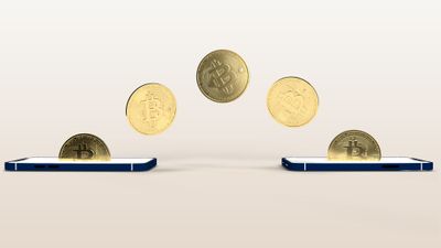 3D render of gold coins with Bitcoin symbol floating in an arc from one smartphone to another.jpg