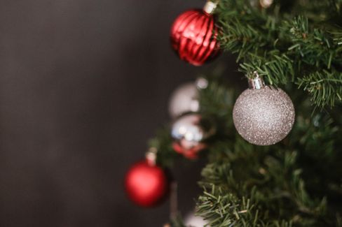 close photo of red and silver ornaments hanging from a tree.jpg