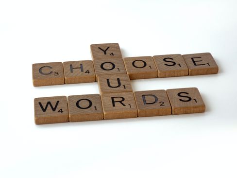 a set of wooden squares with letters printed on them spelling out CHOOSE YOUR WORDS in a crossword style.jpg.jpg