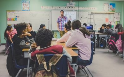 A teacher teaches a classroom of students