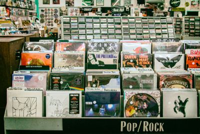 Shelf at record store displaying records that span the pop to rock genres.jpg