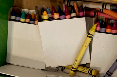 Crayons of many colors in and out of boxes. Photo by Susan Bernstein, October 19 2023
