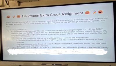 Halloween Extra Credit Assignment projected on a classroom smart board. The last line is whited out to protect instructor's email address and submission platform information. The assignment follows. Photo by Susan Bernstein October 31, 2023