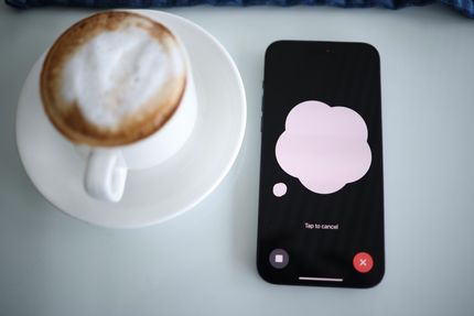 photo of ChatGPT on a smartphone and a cup of coffee.jpg