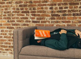 photo of stressed-out student lying down with book splayed over their face.jpg